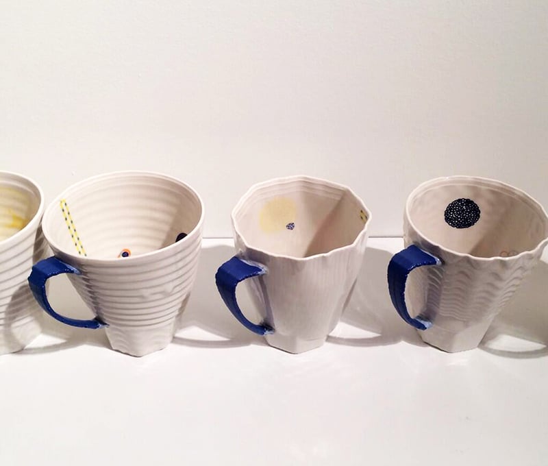 Ceramic artist Andy Brayman’s “Cups” on display at Ontario Craft Council Gallery's Hand & Machine exhibit. The blue and white 3-D printed porcelain cups feature intricate motifs and decorations, which were created by capturing the movement of Brayman's fingertips and translating it into custom algorithms. Tagged by Tory Healy. 
