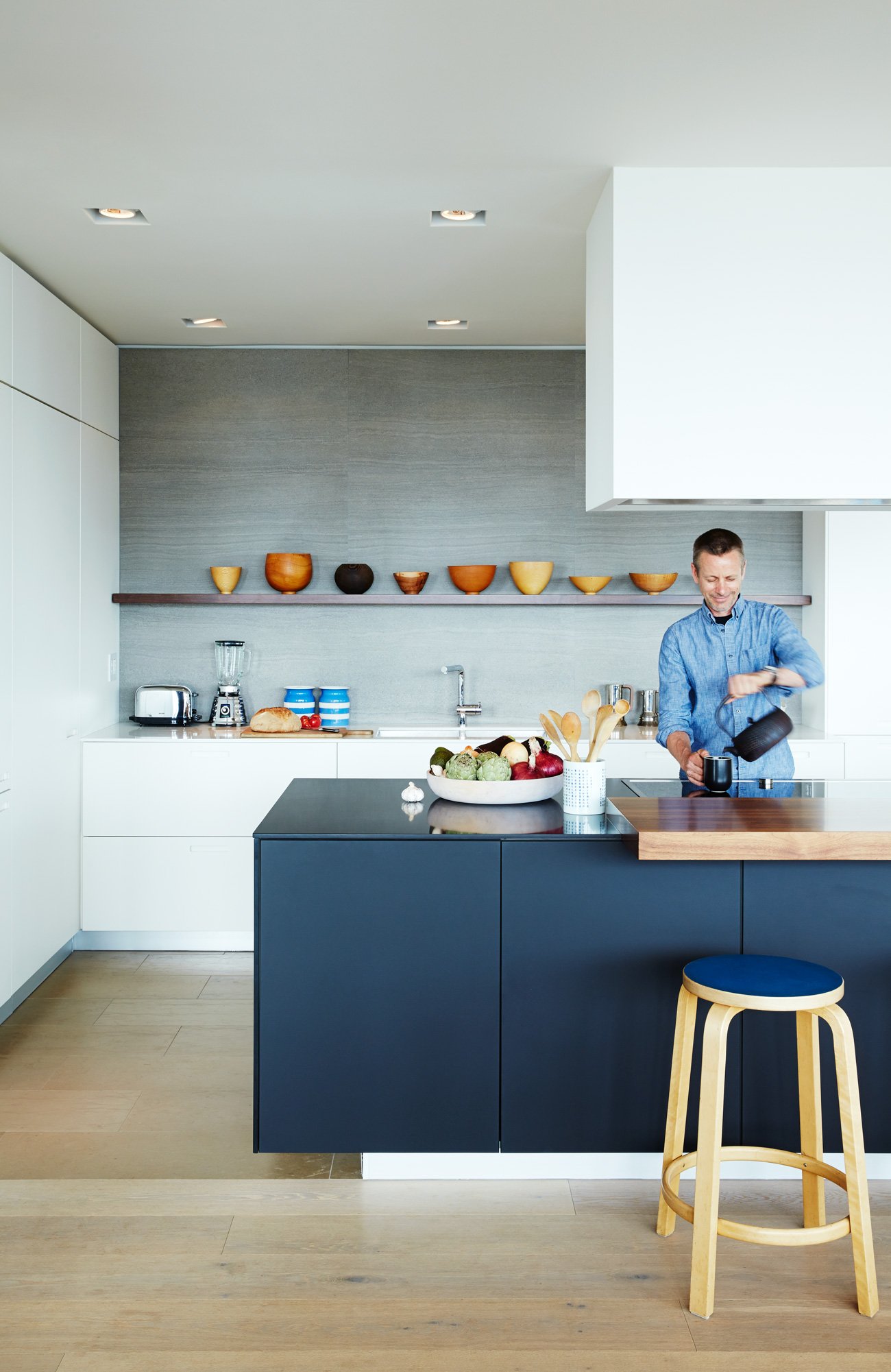 Industrial designer Tom Deacon is preparing a tea in his penthouse