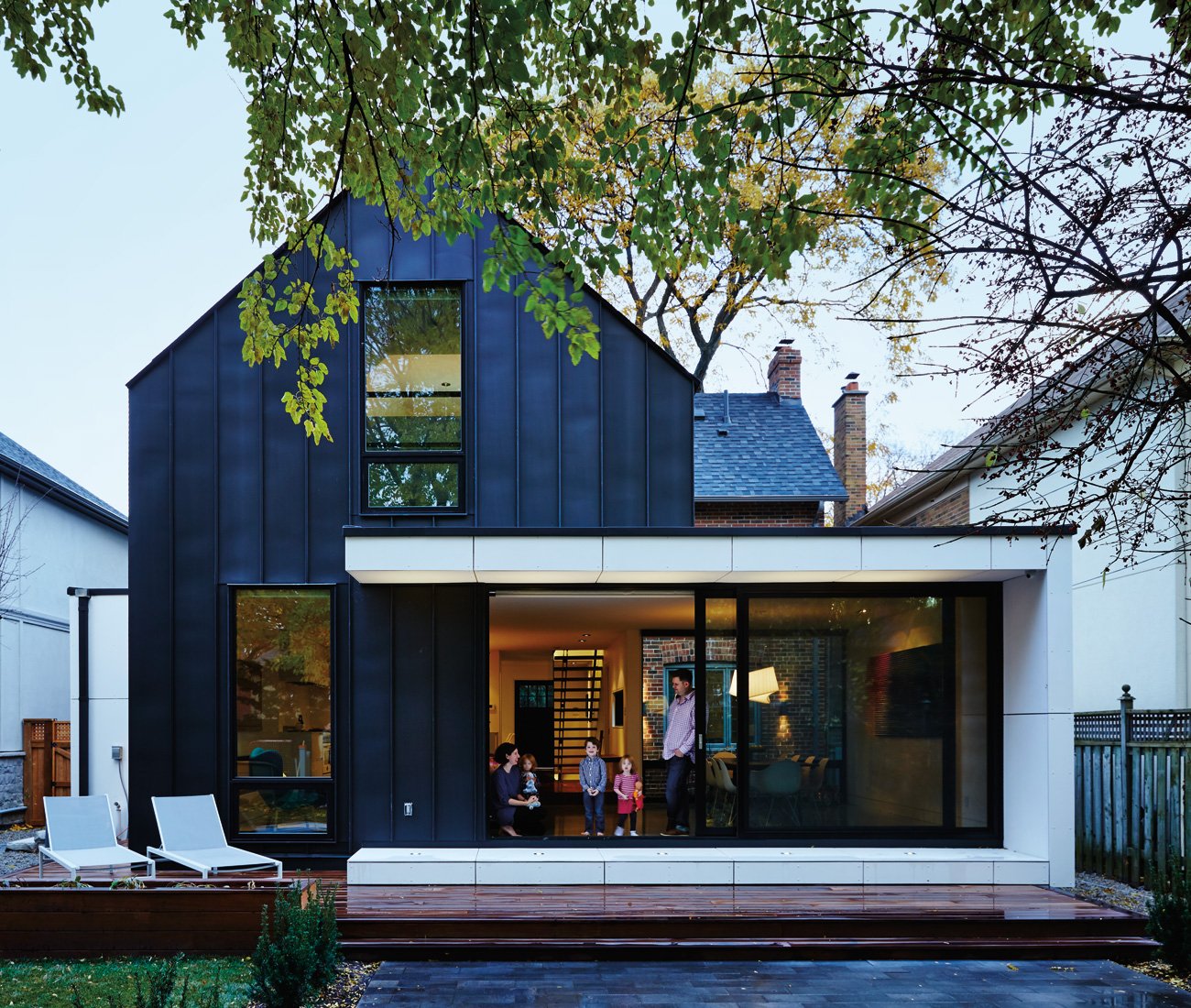 Modern garden design with concrete, zinc panels, and a wood platform.